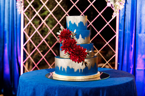 Closeup of white wedding cake with flowers. Wedding ceremony.