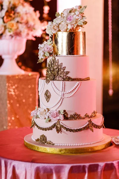 Closeup of white wedding cake with flowers. Wedding ceremony.