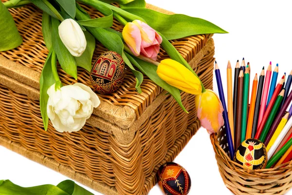 Easter eggs and tulips. Colored pencils in knitted weight. Easter eggs from tulips on a white background. Easter holiday concept.