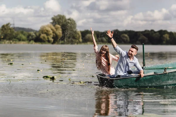Чувствую себя игривым. Красивая молодая пара наслаждается романтическим свиданием на лодке. Счастливы быть вместе . — стоковое фото