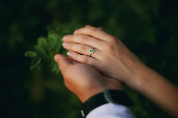 Hands of a young couple with a ring. love, couple, relationship and holidays concept - close up of man giving diamond ring to woman — Stock Photo, Image