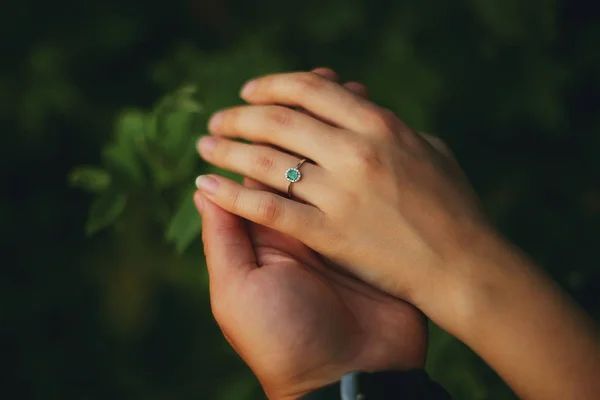 Hands of a young couple with a ring. love, couple, relationship and holidays concept - close up of man giving diamond ring to woman — Stock Photo, Image