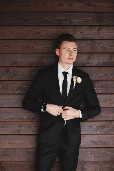 Man\'s style. Elegant young man. Close-up portrait of the man in a luxury classic trendy suit. portrait of the groom. Men\'s beauty, fashion.