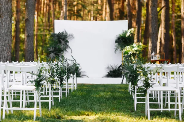 Beautiful wedding set up. Area of the wedding ceremony. Cute, trendy rustic decor. Part of the festive decor, floral arrangement. blurred background. selective focus.