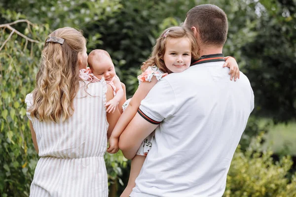 Young couple with newborn daughter in park. happy parenthood, childhood — Stock Photo, Image