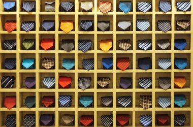 Wall grid filled with rolled neckties for sale at a market stall in Southeast Asia clipart