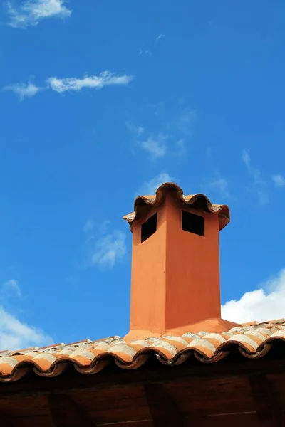 Renkli adobe baca ve kil kiremit parlak mavi gökyüzü ve incecik beyaz bulutlar güneşli güneybatı Amerika'da ek yükü ile