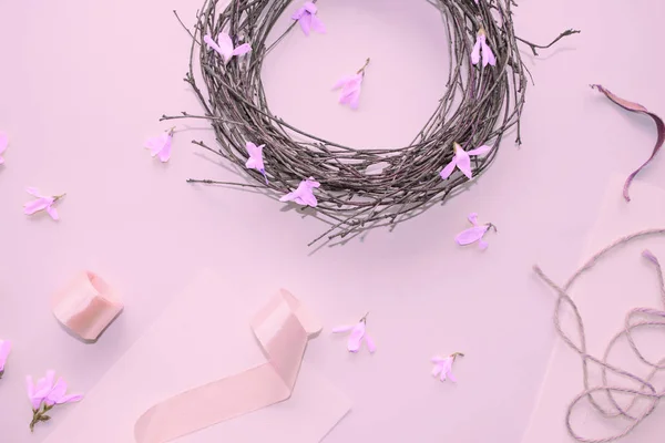 Flowers and wreath. Light pink background. Backdrop with flowers and decorations. Cards. Elegant decor.