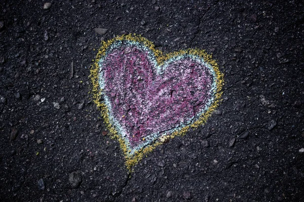 Colorfull heart. Children drawing. Drawings chalk on the asphalt