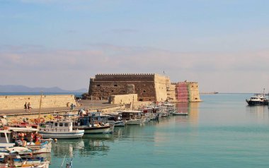 Açık yeşil deniz, pembe bulutlar yatlar ve eski kale, güzel bir akşam ışık, eski Körfezi panoramik görüş