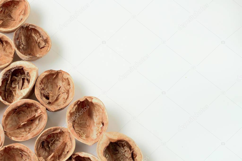 Walnuts chopped on a white background with copy space, bright colors, high contrast.