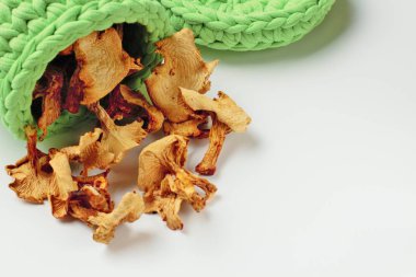 Chanterelle mantarör, beyaz arka plan, parlak renkler, yüksek kontrastlı bir hasır yeşil sepet içinde saklanır.