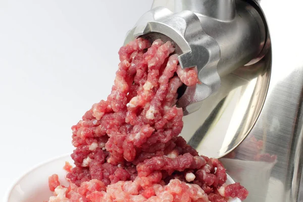 Home meat grinder makes minced pork, juicy colors, high contrast.