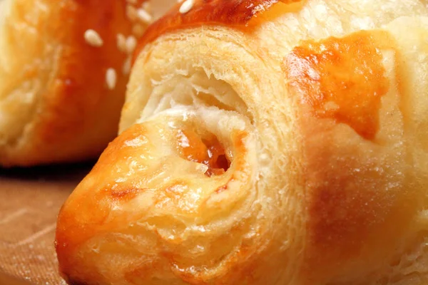 Homemade croissants with apricot jam and sesame seeds are fresh from the oven