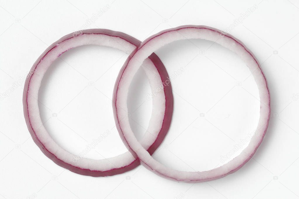 Red bow rings in the form of wedding rings on a white background, bright natural color