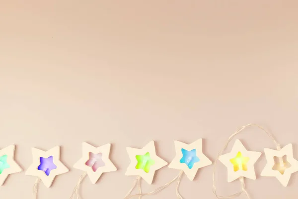 Garland Stars Colored Lamps Beige Surface Festive Background Christmas New — Stock Photo, Image