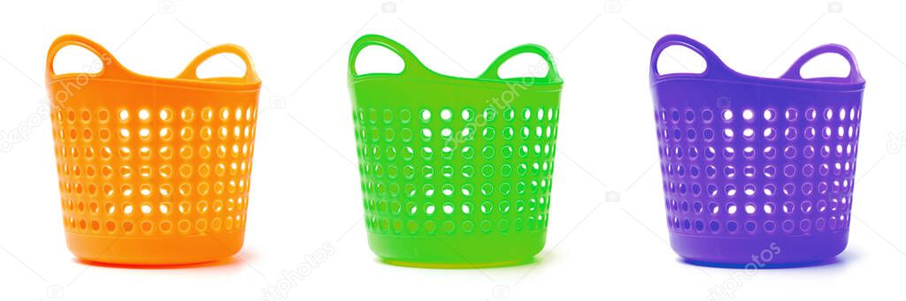 Three colored baskets for separate garbage, linen or goods. Close-up white background, isolate.