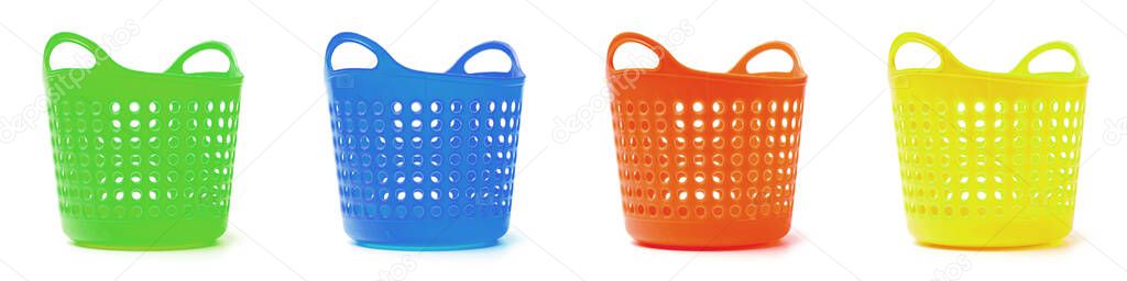 A line of colored baskets for separate waste, linen or goods. close-up white background, isolate.