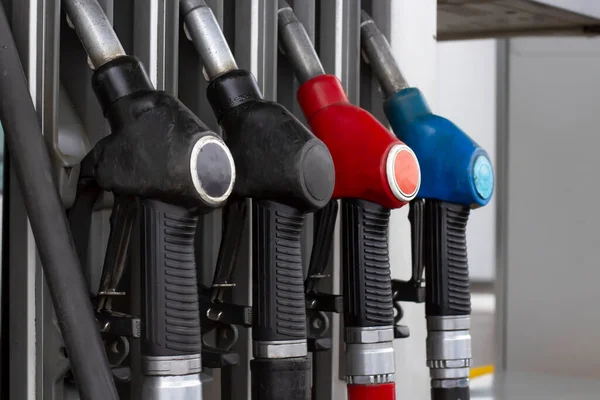 Fuel pistols on a gas station close-up. Car refueling and fuel prices concept.