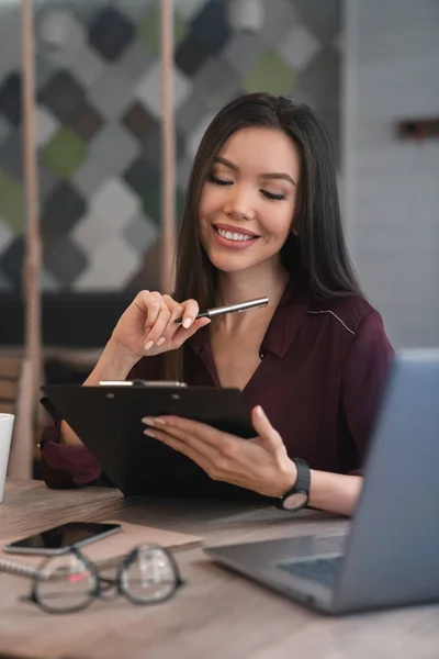 Schöne Junge Frau Blickt Auf Ihre Notizen Der Aktenmappe Und — Stockfoto