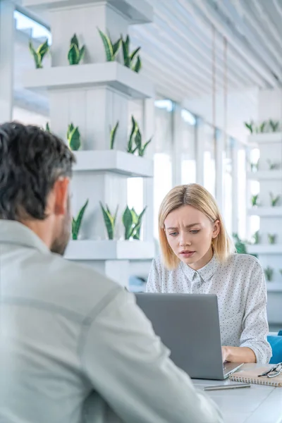 Business woman discussing her ideas with laptop to colleague. Business people meeting in modern office and discussing over new project with some stress situation — Stock Photo, Image