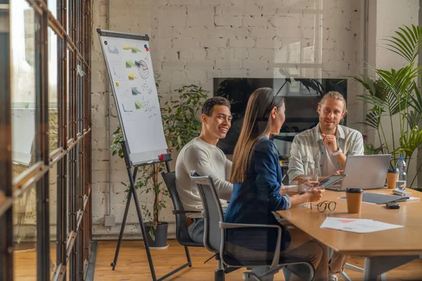 Inomhus skott av kreativt team diskuterar idéer i affärsmöte. Flera etniska affärspersoner arbetar tillsammans med nya projekt i Office. — Stockfoto