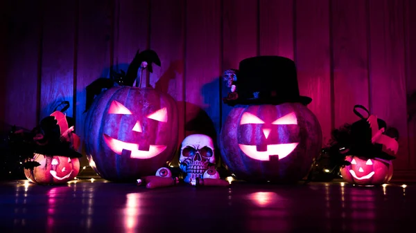 Halloween pumpkin head jack lantern on colored wooden background — 图库照片