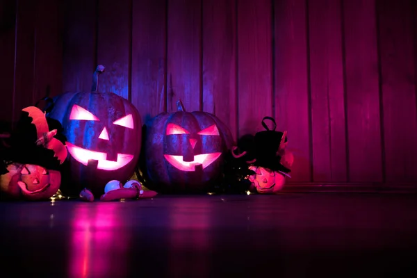 Halloween pumpkin head jack lantern over wooden shining background