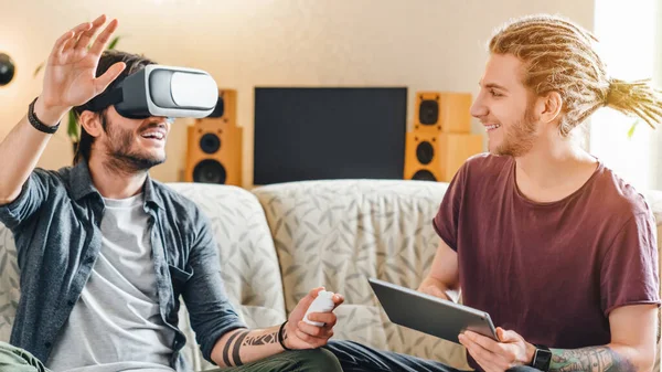 Roommates playing in virtual reality game wearing vr glasses