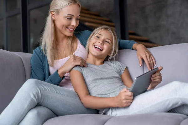 Feliz Madre Hija Divirtiéndose Usando Tableta Digital Sentadas Sofá Sala — Foto de Stock