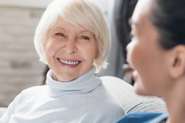 Close Cuidador Sorrindo Conversando Com Mulher Idosa Enquanto Cuida Dela — Fotografia de Stock