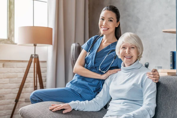 Portret Van Gelukkige Oudere Vrouw Met Verpleegster Thuis — Stockfoto