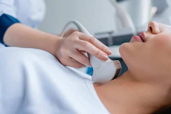 Klinikteki kadının ultrason muayenesi için doktora yakın durun.