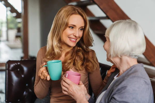 Mature Woman Adult Daughter Resting Sofa Enjoying Coffee Tea Royalty Free Stock Images