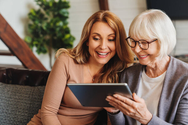 Positive Senior Woman Her Daughter Using Tablet Home Stock Photo