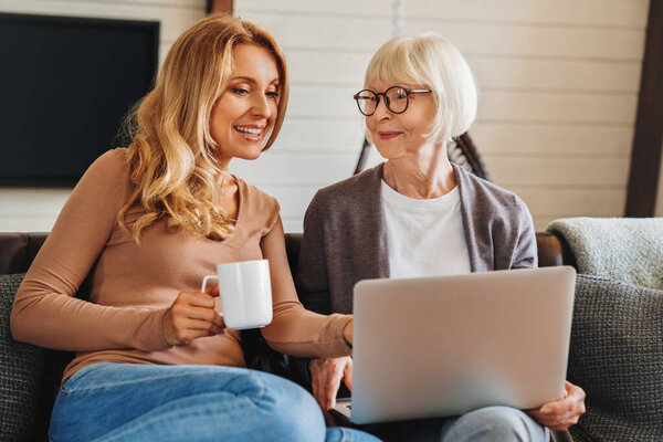 Happy Mature Woman Her Adult Daughter Smiling While Sitting Sofa Royalty Free Stock Photos