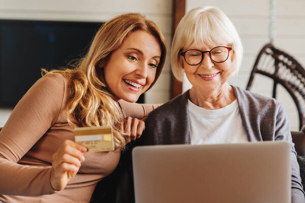 Shopping Online Senior Woman Her Middle Aged Daughter Shopping Online Royalty Free Stock Photos