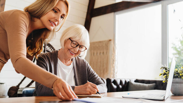 Insurance Agent Standing Front Laptop Giving Advise Senior Woman Stock Picture