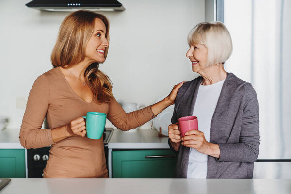 Senior Woman Enjoying Meeeting Her Daughter Kitchen Drinking Tea Coffee Stock Image