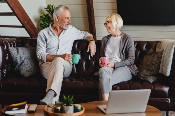 Joyful Mature Man Woman Drinking Coffee While Resting Couch Home — Stock Photo, Image