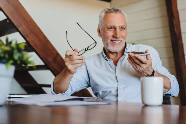 Senior Smiling Man Working Home Talking Mobile Speaker Phone — Stock Photo, Image