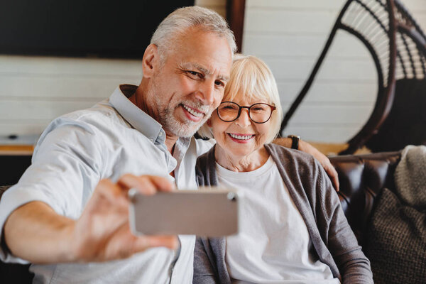 Happy Funny Senior Couple Taking Selfie Looking Smartphone Indoor Stock Picture