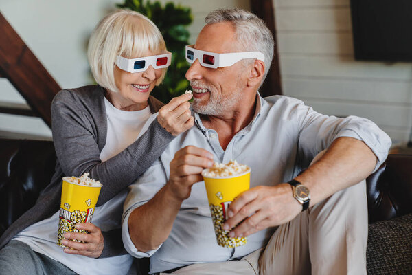 Seniors Glasses Popcorn Sitting Sofa Watching Movie Home Stock Picture