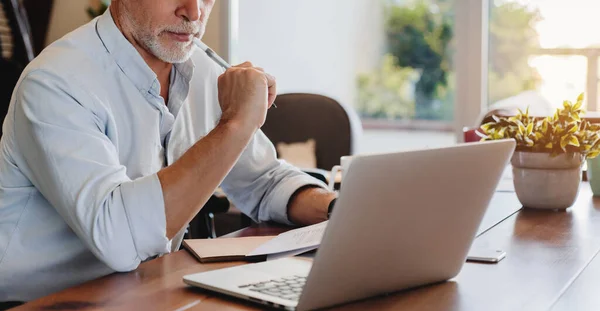 Cropped Shot Senior Man Using Laptop Checking Documents Indoor Stock Image