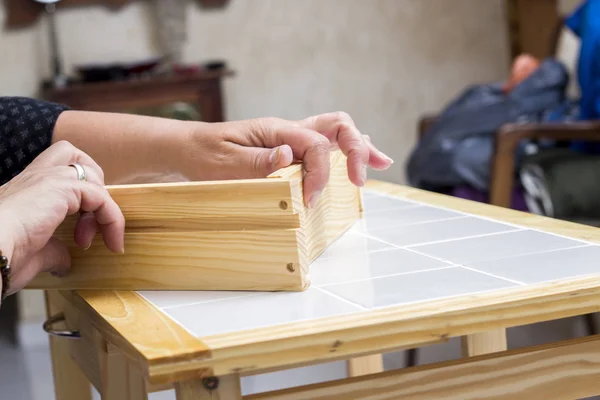 carpenter person checking wardrobe box case in table in workshop