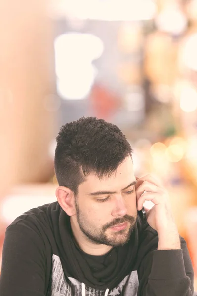 sad man talking on phone