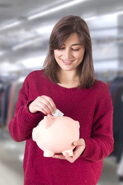 Woman Putting Money Piggy Bank — Stock Photo, Image