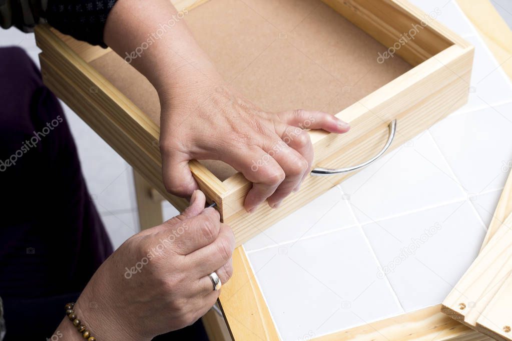 cropped image of carpenter person repairing wardrobe box case