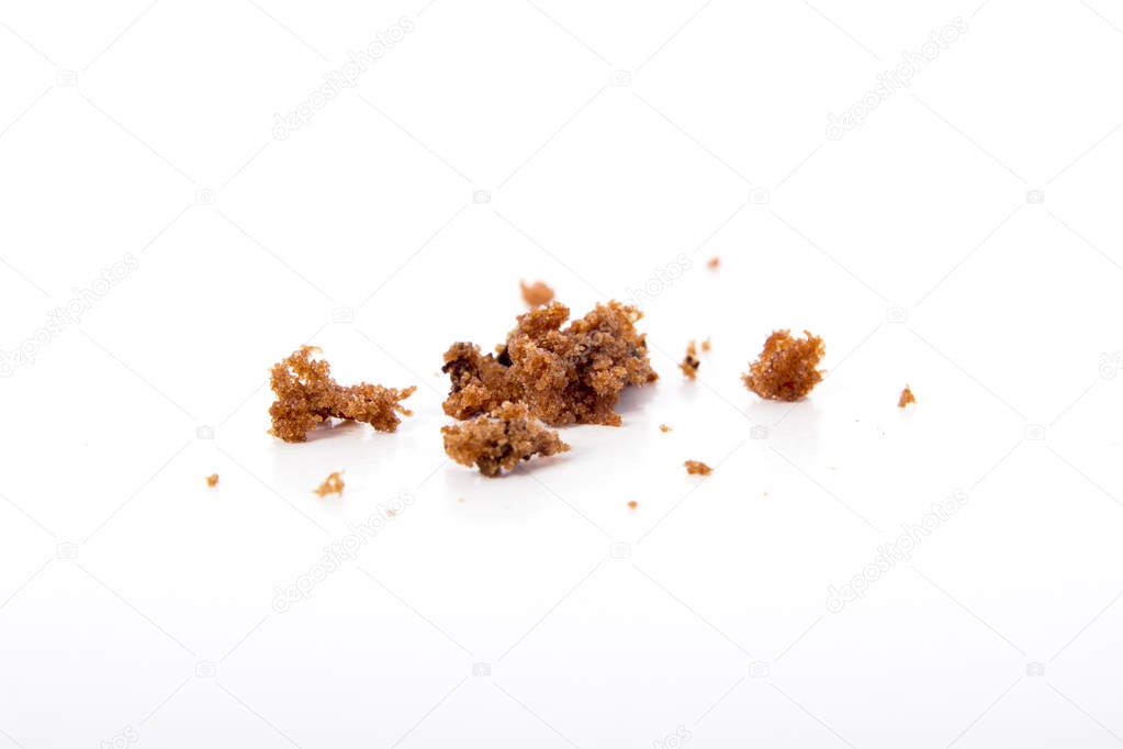 chocolate muffin crumbs on white surface