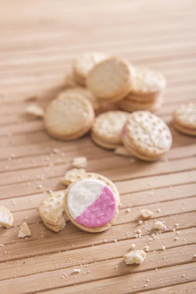homemade cookies with crumbs on wooden table surface
